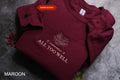 A burgundy sweatshirt with a white embroidered leaf design and the text "I remember it all too well" printed on it.